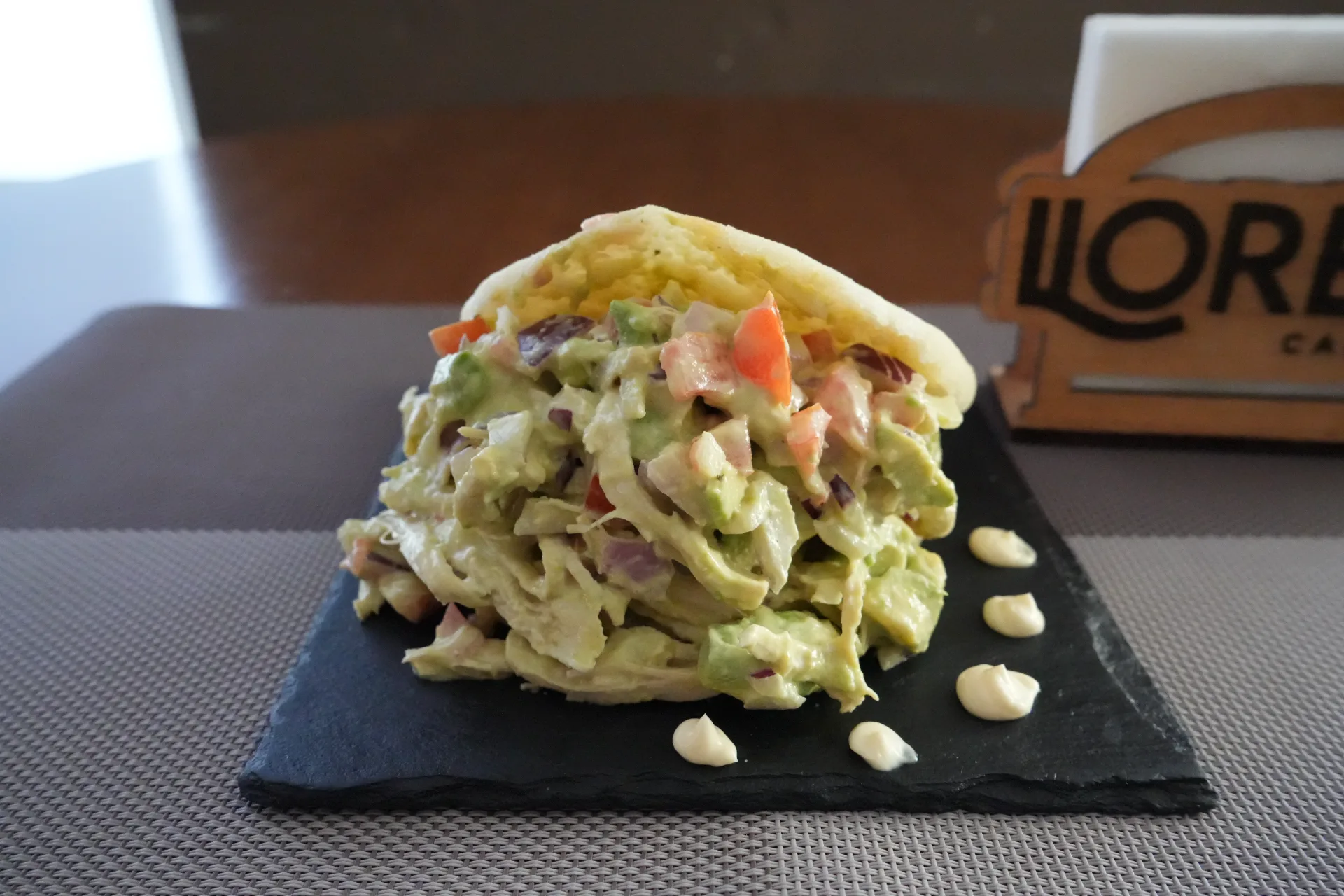 Arepa Reina Pepiada con Pollo Desmenuzado, Aguacate, Cebolla Morada, Mayonesa, Zumo de Lima y Tomate, de Bar Llorens, en la Jornada de Cocas de Dénia